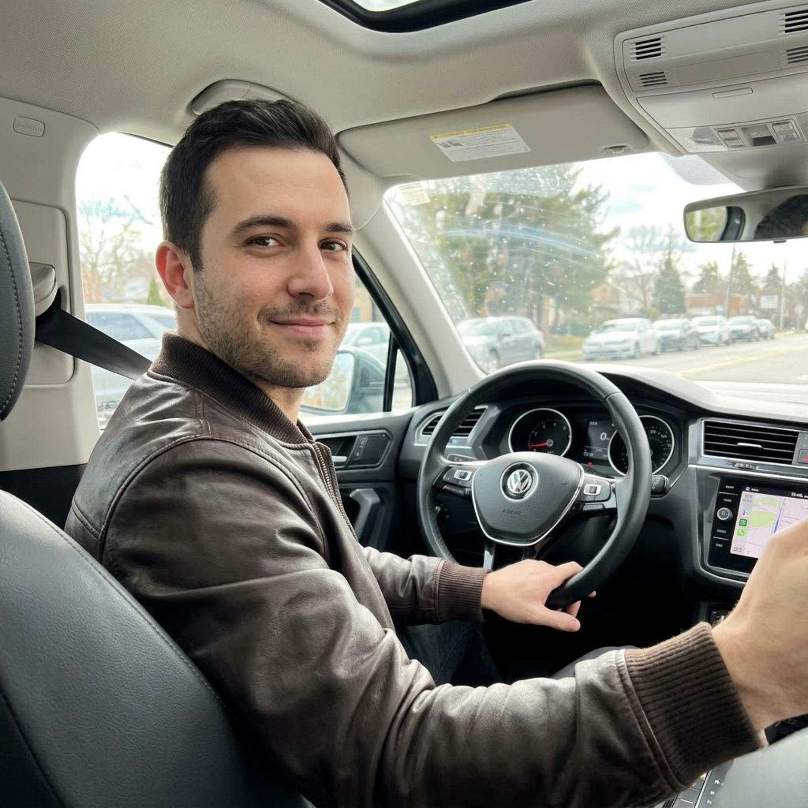 man wearing rove leather jacket sitting in his driving seat about to go somewhere