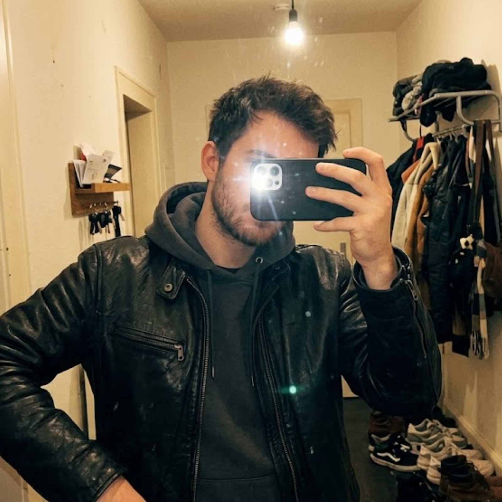 man taking a selfie picture in his home wearing rove leather jacket