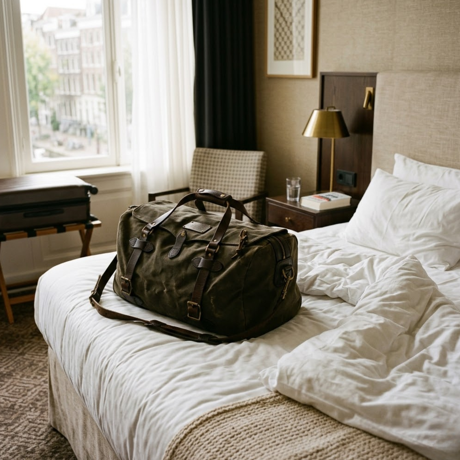 Rove leather duffel bag put on a bed in home
