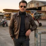 Man wearing dark brown leather aviator jacket at airfield - Rove Leather Meridian