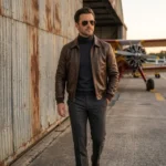 Man wearing dark brown leather aviator jacket at airfield - Rove Leather Meridian