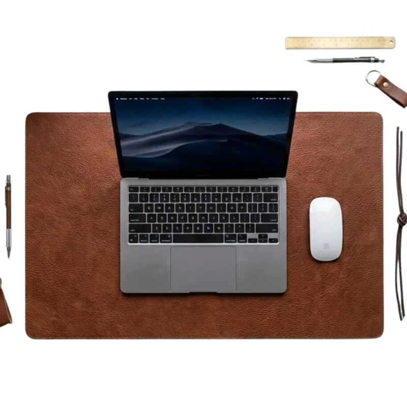 Cognac brown full-grain leather desk pad with MacBook and Apple Magic Mouse on white background — Rove Leather